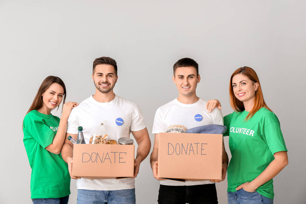 Volontari con donazioni per i poveri su sfondo chiaro
 - Foto, immagini