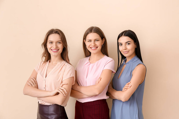 Beautiful young businesswomen on color background - Valokuva, kuva