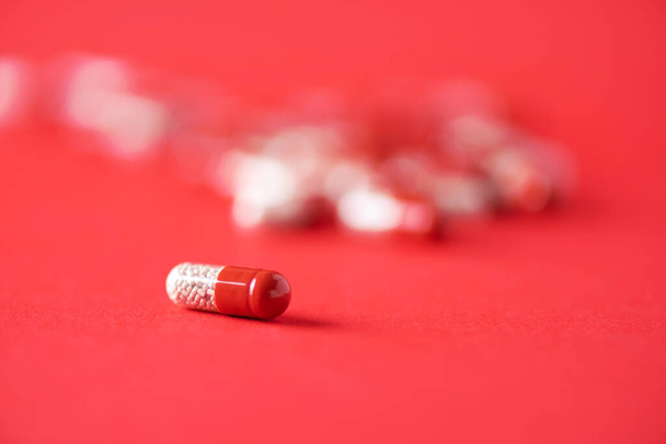 Macro of red capsules on red background. Copy space. Bunch of drugs, cold flu treatment. Coronavirus Covid-19. - Fotoğraf, Görsel