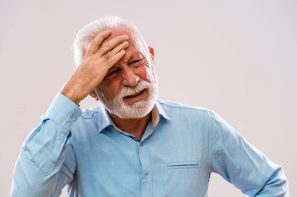 Portrait of senior man who is having headache. - Foto, Bild