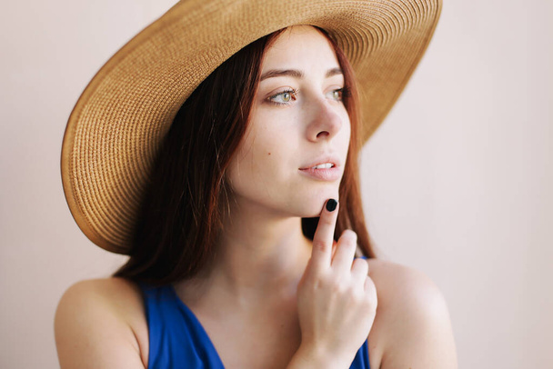 Young pretty happy woman in a dress. A beautiful smiling girl in a hat. Romantic shot. Fashion style photo of a spring women - Foto, imagen
