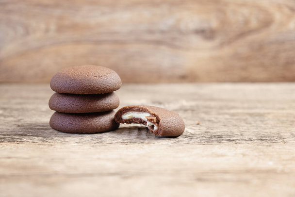 Chocolate round cookies on a wooden background. - Photo, Image