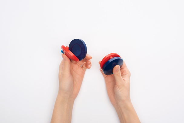 Cropped view of woman holding castanets on white background - Photo, Image