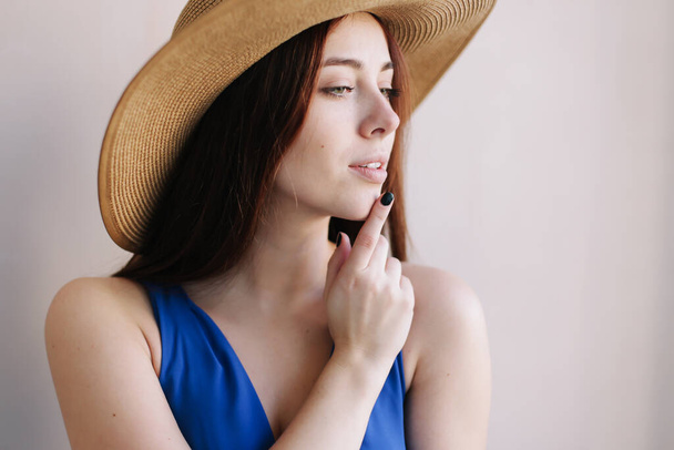 Young pretty happy woman in a dress. A beautiful smiling girl in a hat. Romantic shot. Fashion style photo of a spring women - Foto, Imagem