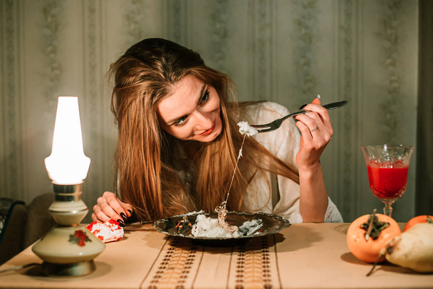 Girl in night gown having dinner. Lard with hair. Bizarre, disturbing concept - Photo, Image