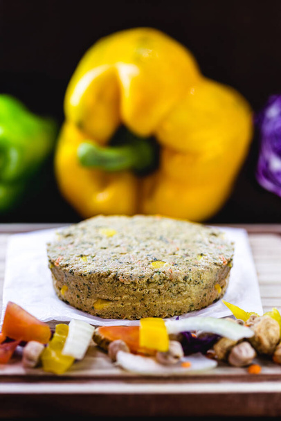 homemade vegan hamburger without meat, made from vegetables on rustic wooden background with colorful vegetables. Vegetarian life and vegetarian life concept. - Photo, Image