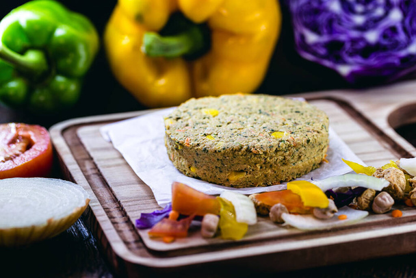 homemade vegan hamburger without meat, made from vegetables on rustic wooden background with colorful vegetables. Vegetarian life and vegetarian life concept. - Photo, Image