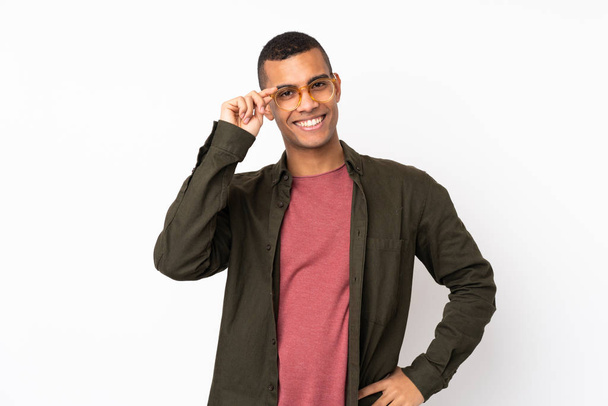 Young African American man over isolated white background with glasses and happy - Fotoğraf, Görsel