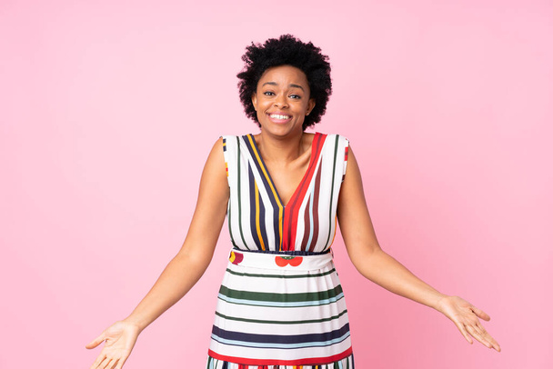 Afrikanische Amerikanerin über isoliertem rosa Hintergrund lächelnd - Foto, Bild