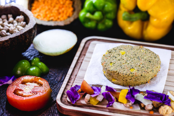 homemade vegan burger, with vegetables and various grains, on rustic wooden background. Healthy and vegetarian life concept. meatless snack. - Photo, Image