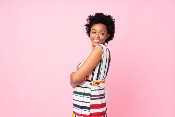 African american woman over isolated pink background with arms crossed and happy - Фото, зображення