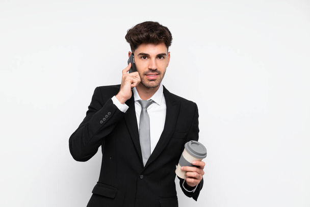 Young businessman holding coffee to take away over isolated white background - Foto, immagini