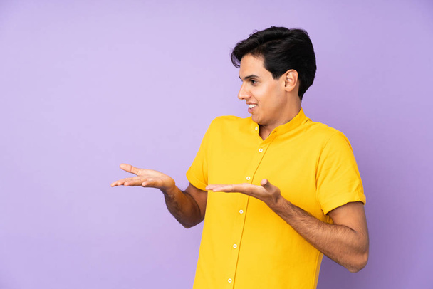 Man over isolated purple background with surprise facial expression - Photo, image