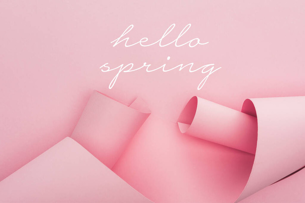 top view of pink paper swirls on pink background, hello spring illustration - Φωτογραφία, εικόνα