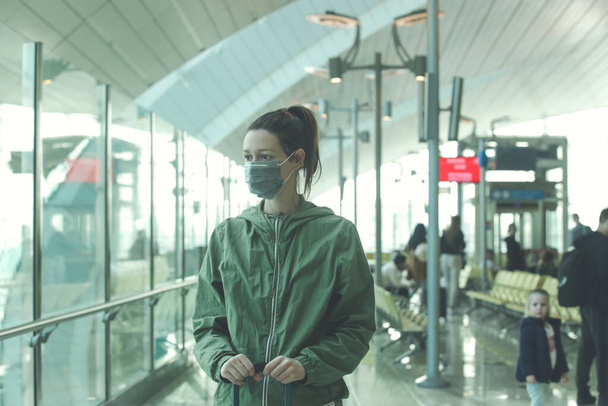 Жінка, одягнена в захисну маску в аеропорту, зараження коронавірусом побоюється концепції - Фото, зображення