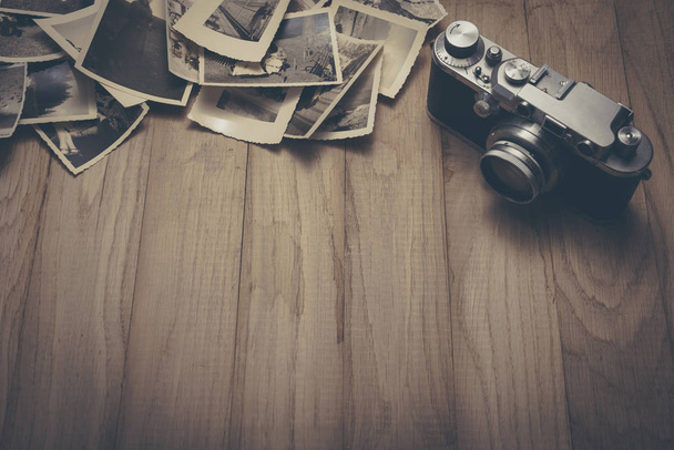 Vintage photo camera with old photos. - Photo, Image