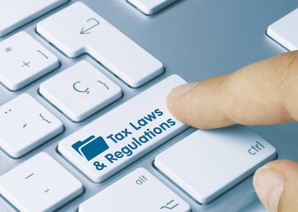 Tax Laws & Regulations Written on Blue Key of Metallic Keyboard. Finger pressing key - Photo, Image