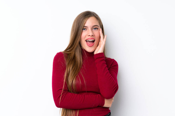 Teenager blonde girl over isolated white background with surprise and shocked facial expression - Zdjęcie, obraz