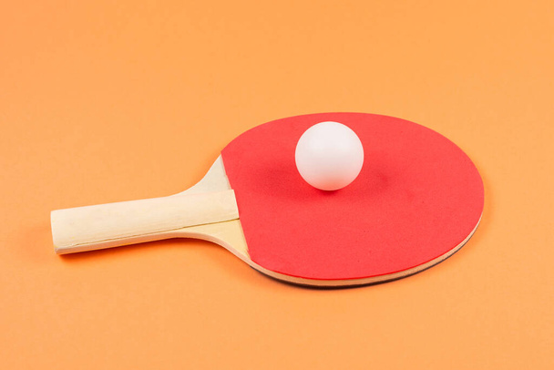 Pin pong on an orange background.  Top view.  - Фото, зображення