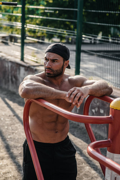 A fitness athlete trains on a sports field. Healthy lifestyle - Zdjęcie, obraz