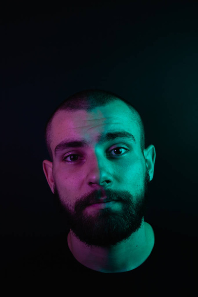 Portrait of a hipster guy with color light. Hipster face portrait in studio. - Photo, Image