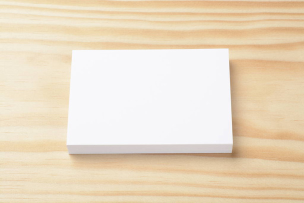 Blank commercial business cards wad on wooden background - 写真・画像