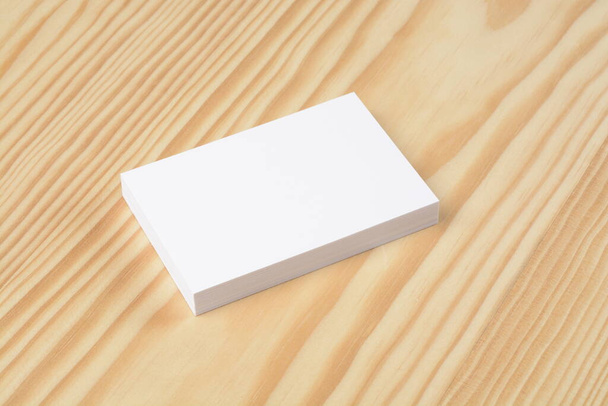 Blank commercial business cards wad on wooden background - Foto, imagen