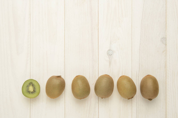 Kiwis on wooden background, composition as background - Photo, Image