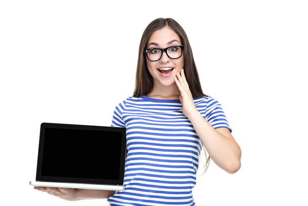 Young girl in eyeglasses with laptop computer isolated on white background - Valokuva, kuva