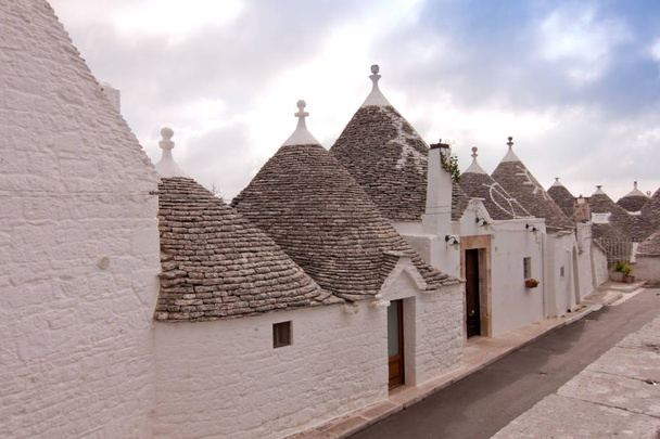 village with cone-shaped roof houses Alberobello Puglia Italy - Photo, Image