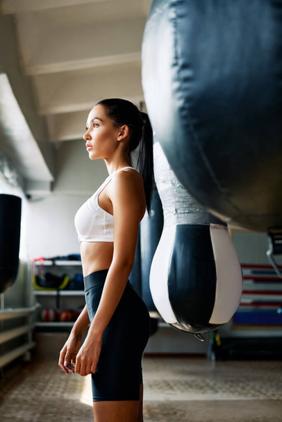 Young sporty woman posing in fitness gym. Healthy lifestyle and sport concept                 - 写真・画像