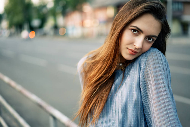 Close up young beautiful woman portrait posing in the city street in summer         - 写真・画像