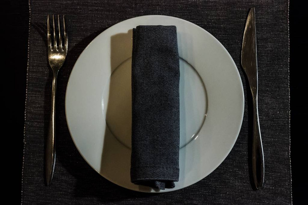 A plate with fork and knife in the cafe on the table - Fotoğraf, Görsel