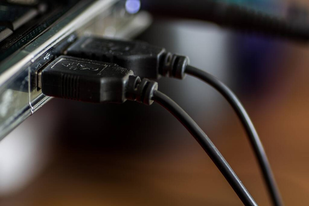 A closeup shot of cables plugged into a port of a laptop - Valokuva, kuva