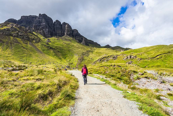 A hiker on the footpath to the famous rock Old Man of Storr, Isle of Skye, Scotland - Фото, зображення