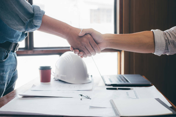 Meeting and greeting, Two engineer or architect meeting for project, handshake after consultation and conference new project plan, contract for both companies, success, partnership. - Photo, image