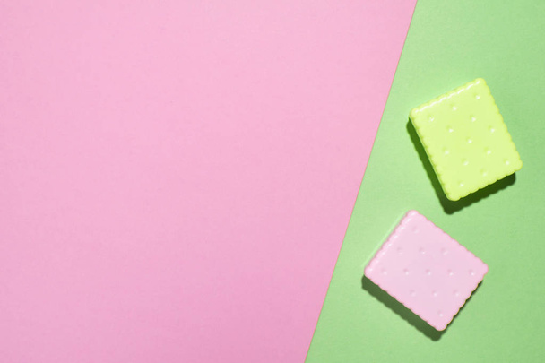 Geometric pink and green layout with two decorative colorful cracker. Creative minimal flat lay. - Φωτογραφία, εικόνα