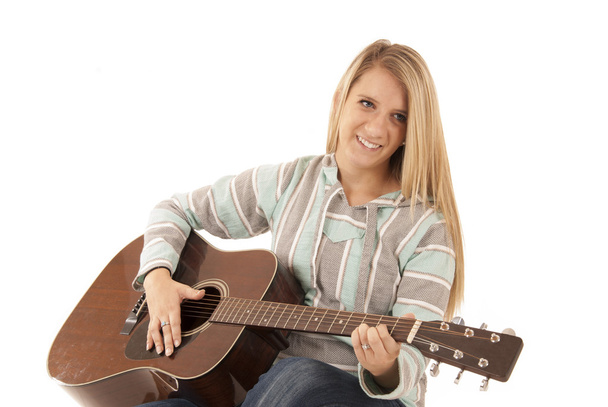Young blonde woman playing acoustic guitar - Fotó, kép