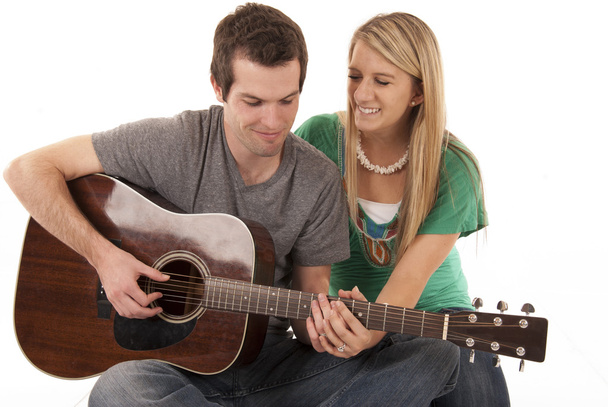 Young couple holding hands playing guitar - Photo, image