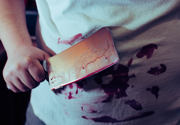 An ax knife in blood, in the hands of a man, clothes in blood - Photo, Image