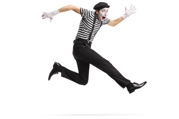 Happy mime jumping isolated on white background - Photo, image