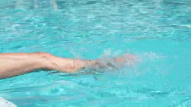 female legs dipping in water in swimming pool - Felvétel, videó