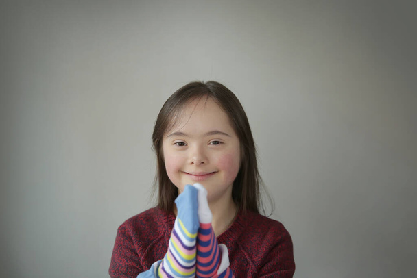 Beautiful girl smiling with different socks - Fotoğraf, Görsel