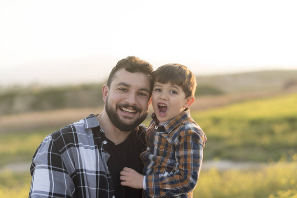 Father and son portrait outdoors looking at camera - Foto, Imagen