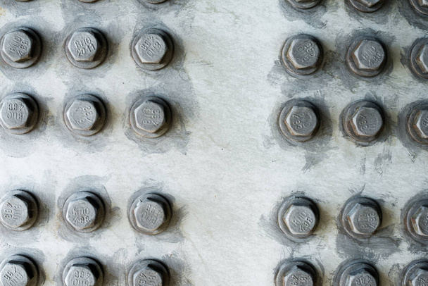 Gray metal surface with hexagonal bolt heads. - Photo, Image