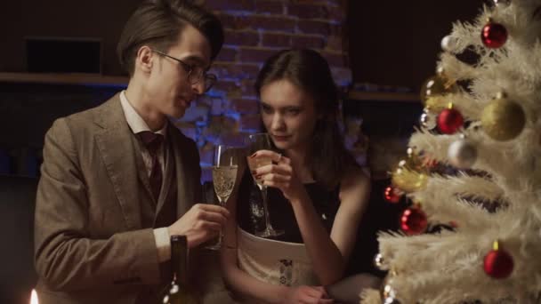 Young man and woman decorating christmas tree, slow motion - Materiał filmowy, wideo