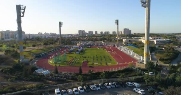 Aerial drone shot above athletic runway stadium. people jogging and challenge olympics competition and training.  - Footage, Video