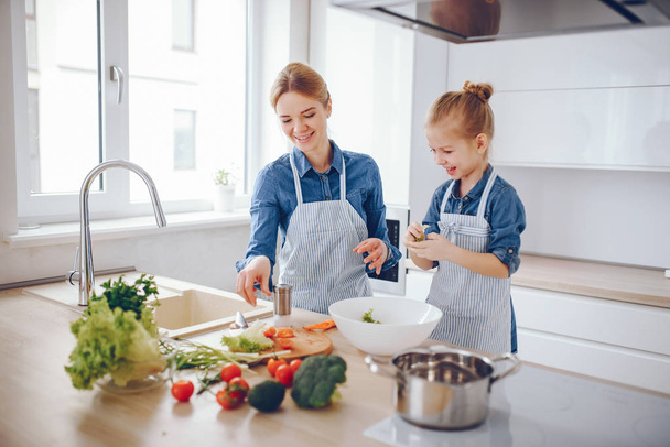 mother with daughter in the kitchen - Photo, Image