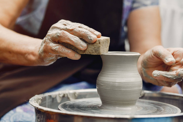 Grandmother with a grandchildren make pitchers in pottery - Fotoğraf, Görsel