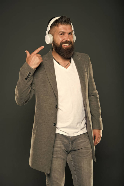 Audio book. Application for listening books. Lifestyle music fan. Man listening music wireless headphones. Hipster use headphones gadget. Inspiring song. Music library. Bearded guy enjoy music - Фото, зображення